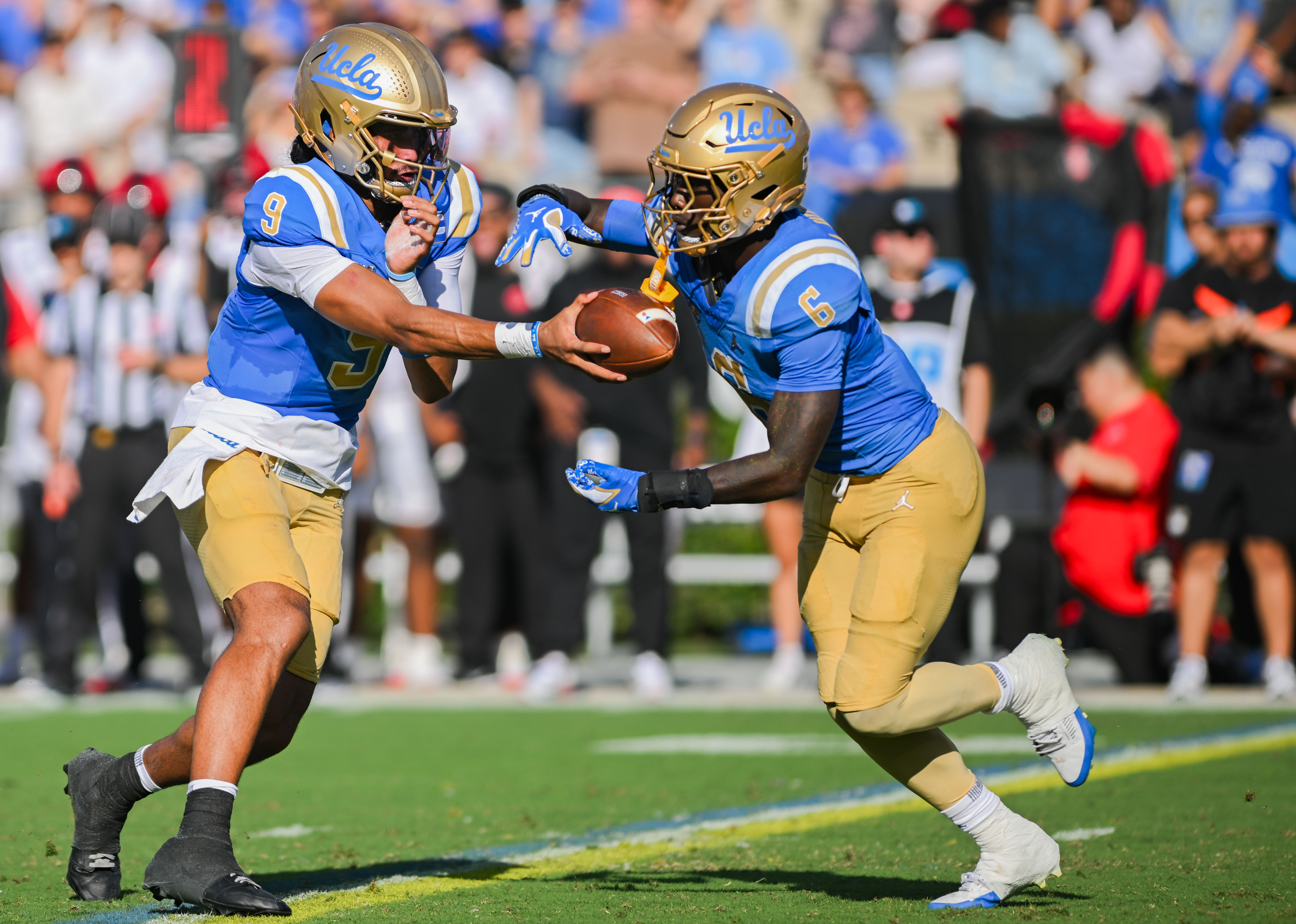 UCLA football senior quarterback Nico Iamaleava hands off the ball to fifth-year running back Anthony Woods during their game against San Diego State on Saturday, September 12, 2026, at the Rose Bowl. (Presley Liu/Daily Bruin senior staff)