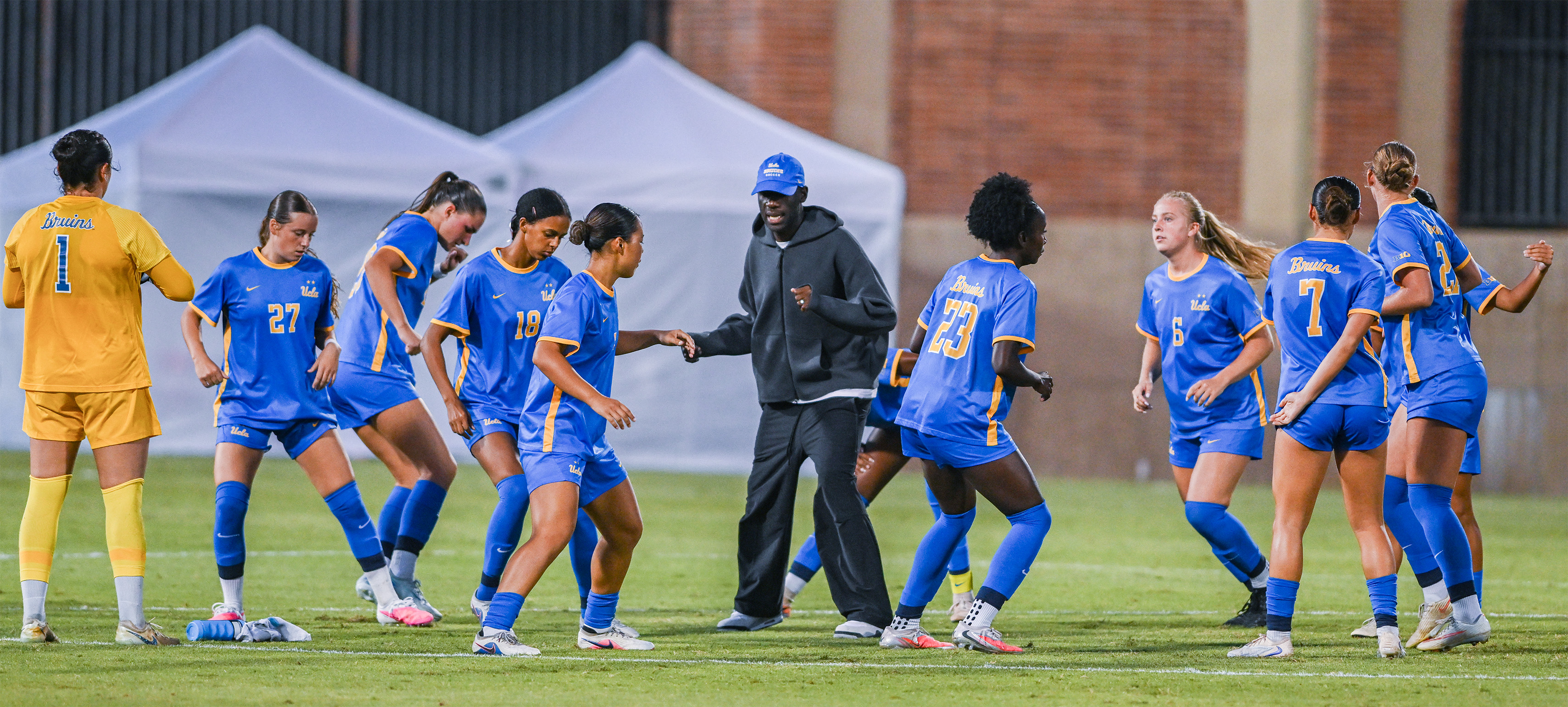 Coach Gof Boyoko leads his team in warmups. Boyoko is in his first season as head coach after four years in an assistant role. (Presley Liu/Daily Bruin senior staff)