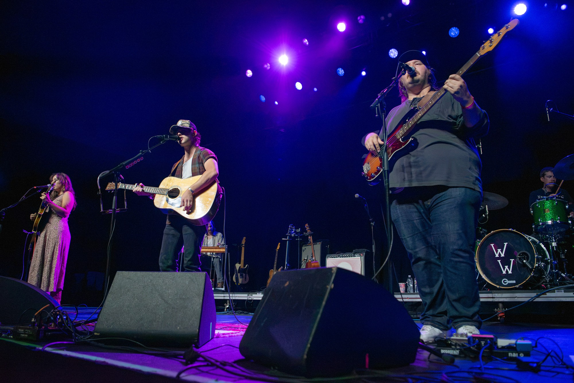 Wyatt and his band stand on stage in blue lighting. He kicked off his world tour back in July, with the LA concert marking his 24th performance of the run. (Selin Filiz/Daily Bruin senior staff)