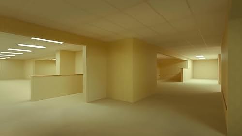 An empty yellow room with corridors and walls is pictured. “Backrooms,” YouTuber-turned-director Kane Parsons’ film, released May 29 about furniture store owner Clark (Chiwetel Ejiofor) who discovers a section of his basement wall he can walk straight through. (Courtesy of IMDb)