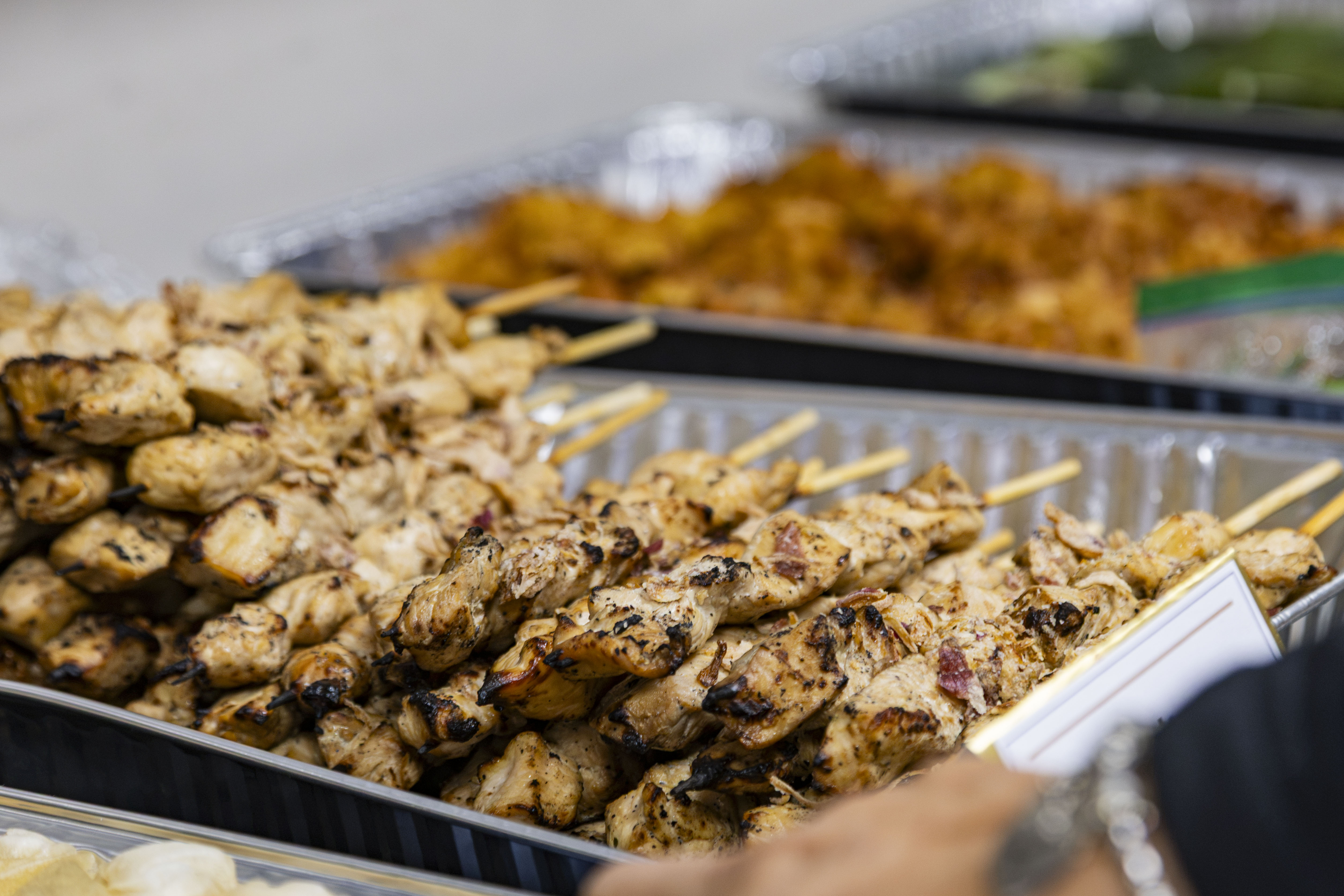 A tray of Indonesian chicken satay skewers is pictured. Dishes served during the reception included Filipino ube crinkle cookies and lumpia alongside lemper ayam, or sticky rice filled with chicken. (Jiah Jung/Daily Bruin)