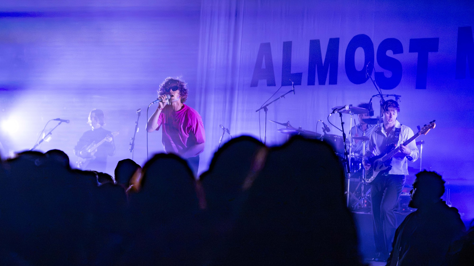 Daugherty (center) holds a mic as he performs on stage with Clisby (left) and Fabry (right). The band played songs such as “she likes sports” and “sequoia." (Joice Ngo/Assistant Photo editor)