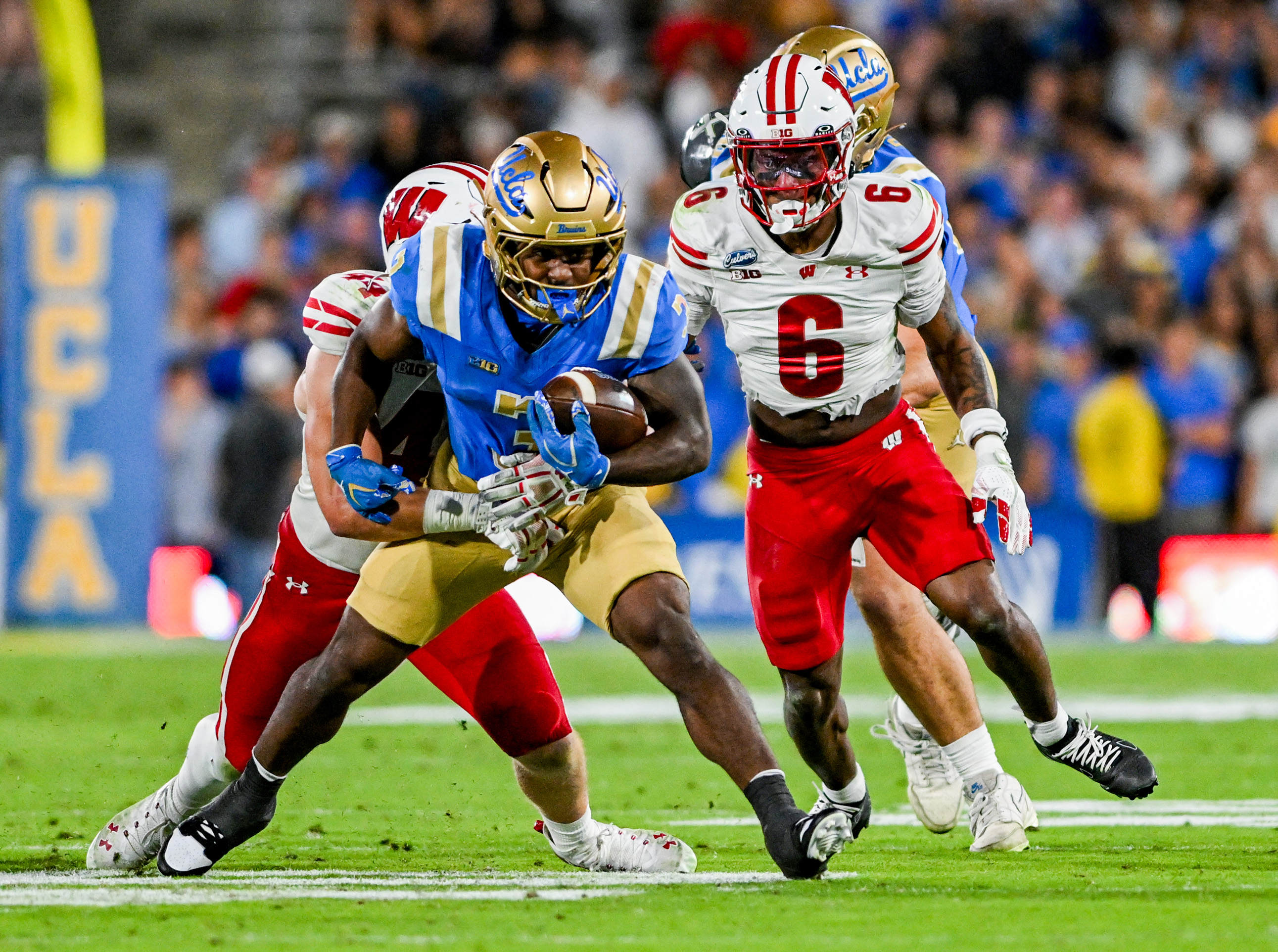 Fifth-year running back Wayne Knight drags a Wisconsin defender as he rushes up field at the Rose Bowl. (William Gauvin/Daily Bruin staff)