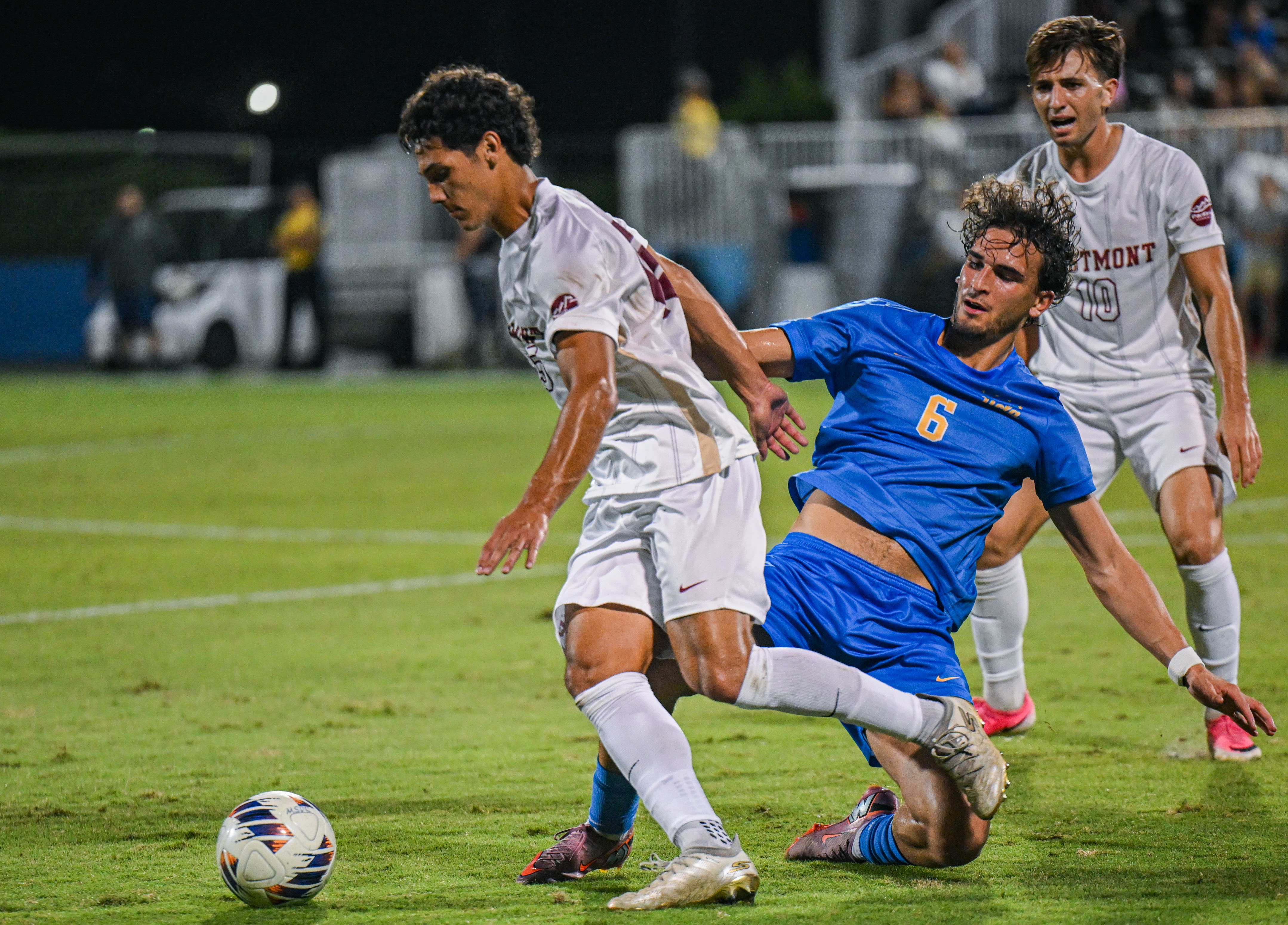 Fifth-year midfielder Diego Martinez slide tackles a Westmont player. Martinez has started in four games for the Bruins, appearing in five. (Miles Turner/Daily Bruin)
