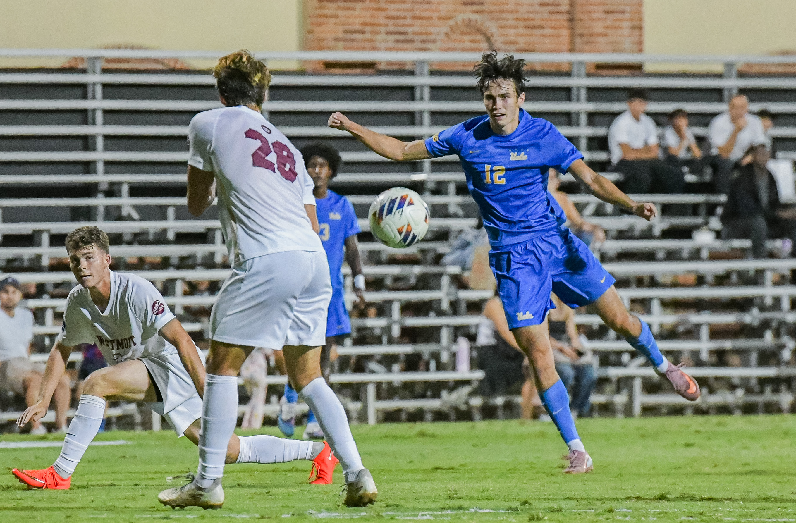 Junior midfielder Zach Neuls runs toward the ball and a Westmont defender. Neuls has scored three goals through the season. (Roger Ayad/Daily Bruin)