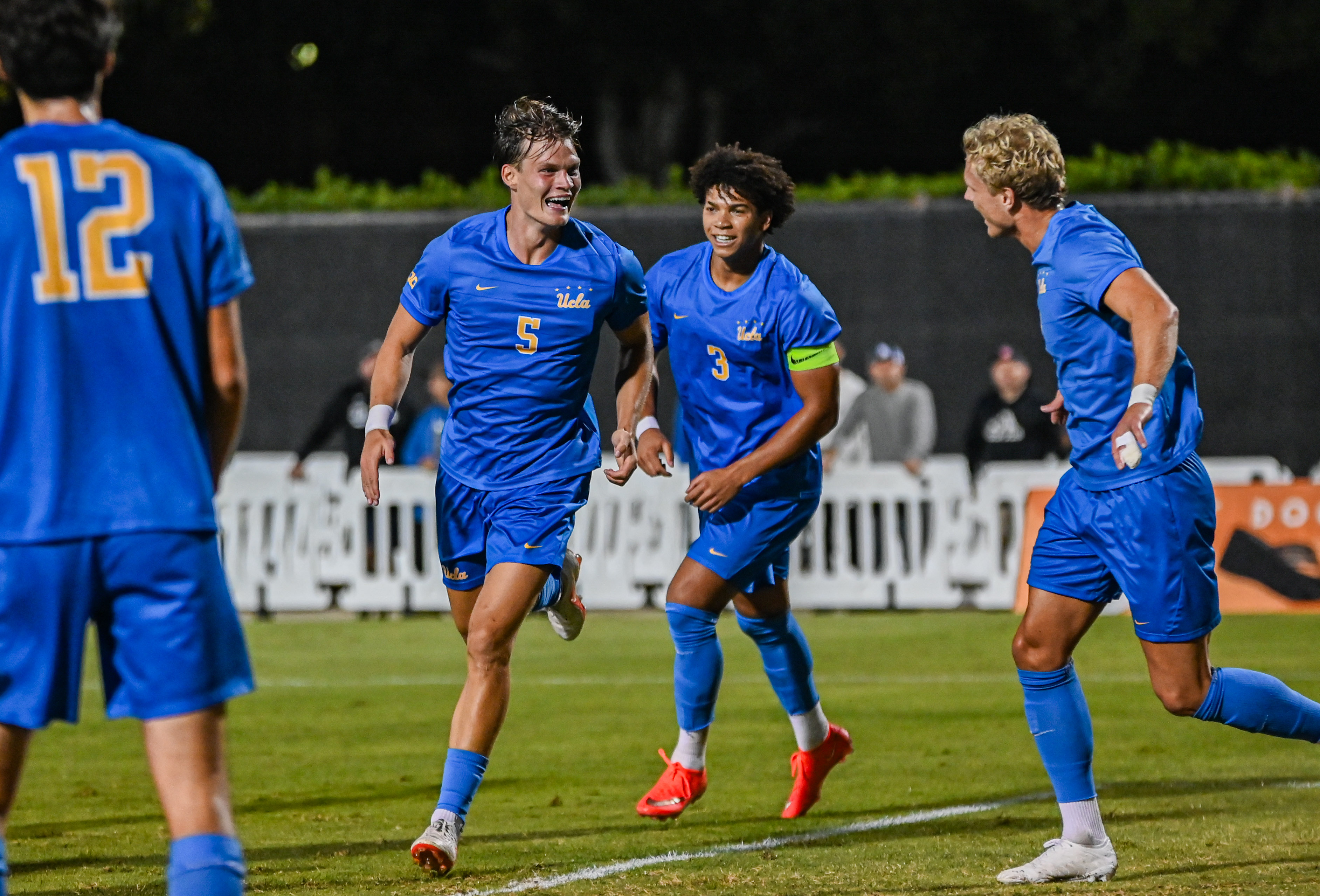Junior defender Mathis Richter (left) celebrates with senior defender Tre Wright (middle) and senior forward Oliver Roche (right) after scoring his first goal of the season. Richter has started all eight games he has appeared in for the Bruins. (Elle Smith/Daily Bruin staff)