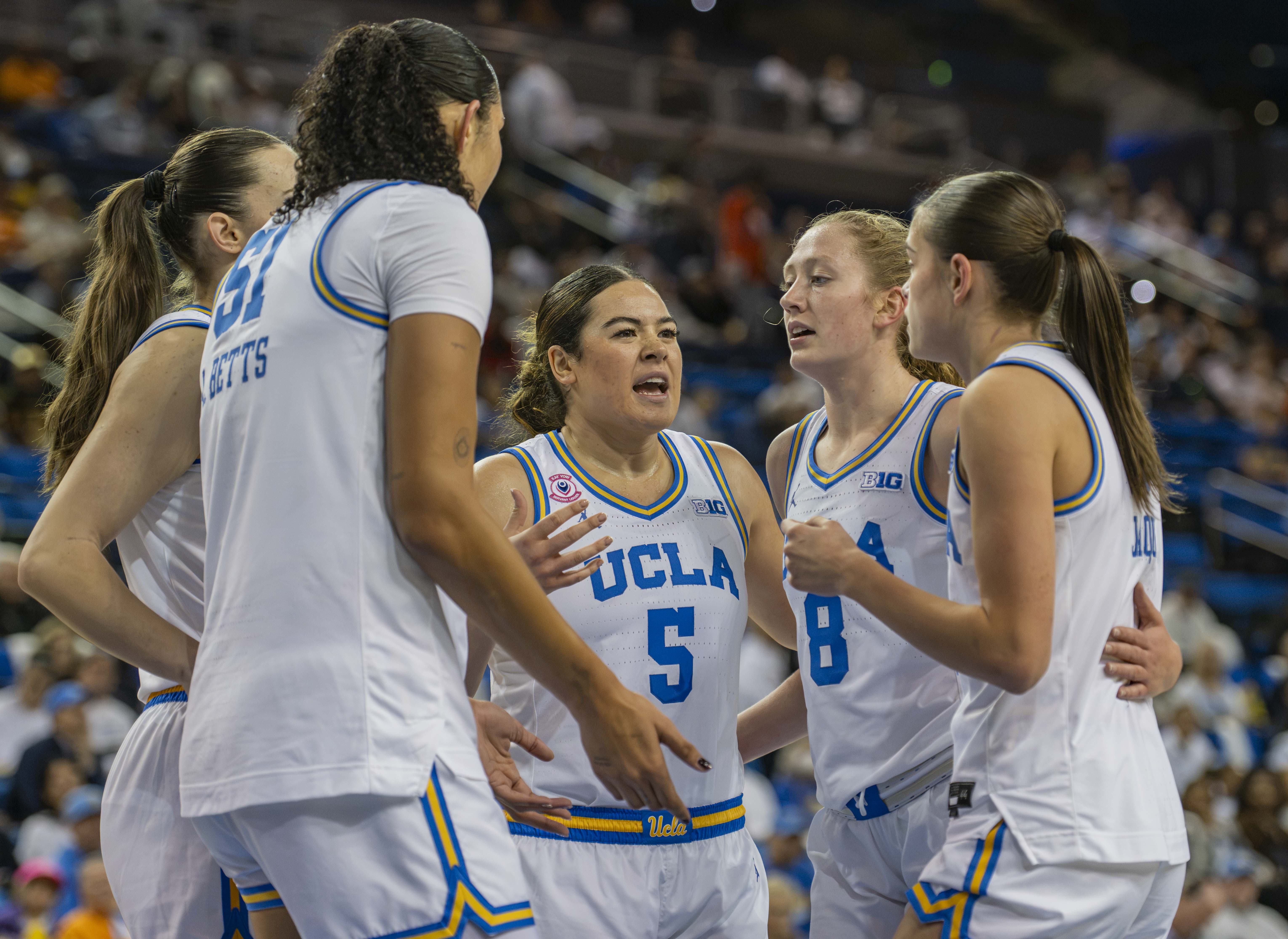 Former Bruin guard Charlisse Leger-Walker (center) speaks to her team in a huddle. Leger-Walker played with UCLA in the 2025-26 season and was selected in the second round of the 2026 WNBA Draft. (Daily Bruin file photo)