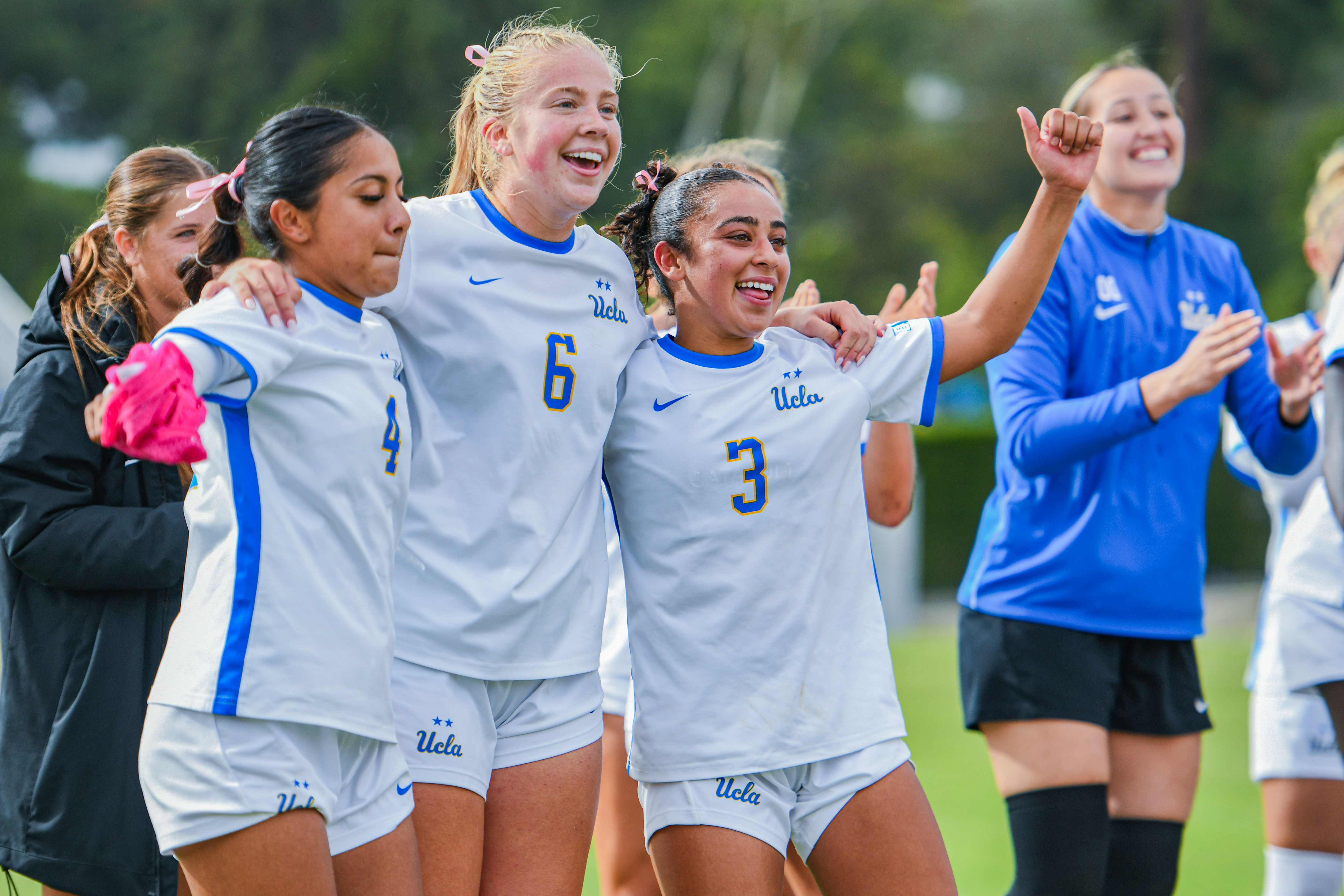 Junior defender Sammy Sanchez (left), sophomore midfielder Grace Shank (middle) and sophomore midfielder Laila Edris (right) celebrate in front of cheering fans after Sunday's win. (Presley Liu/Daily Bruin senior staff)