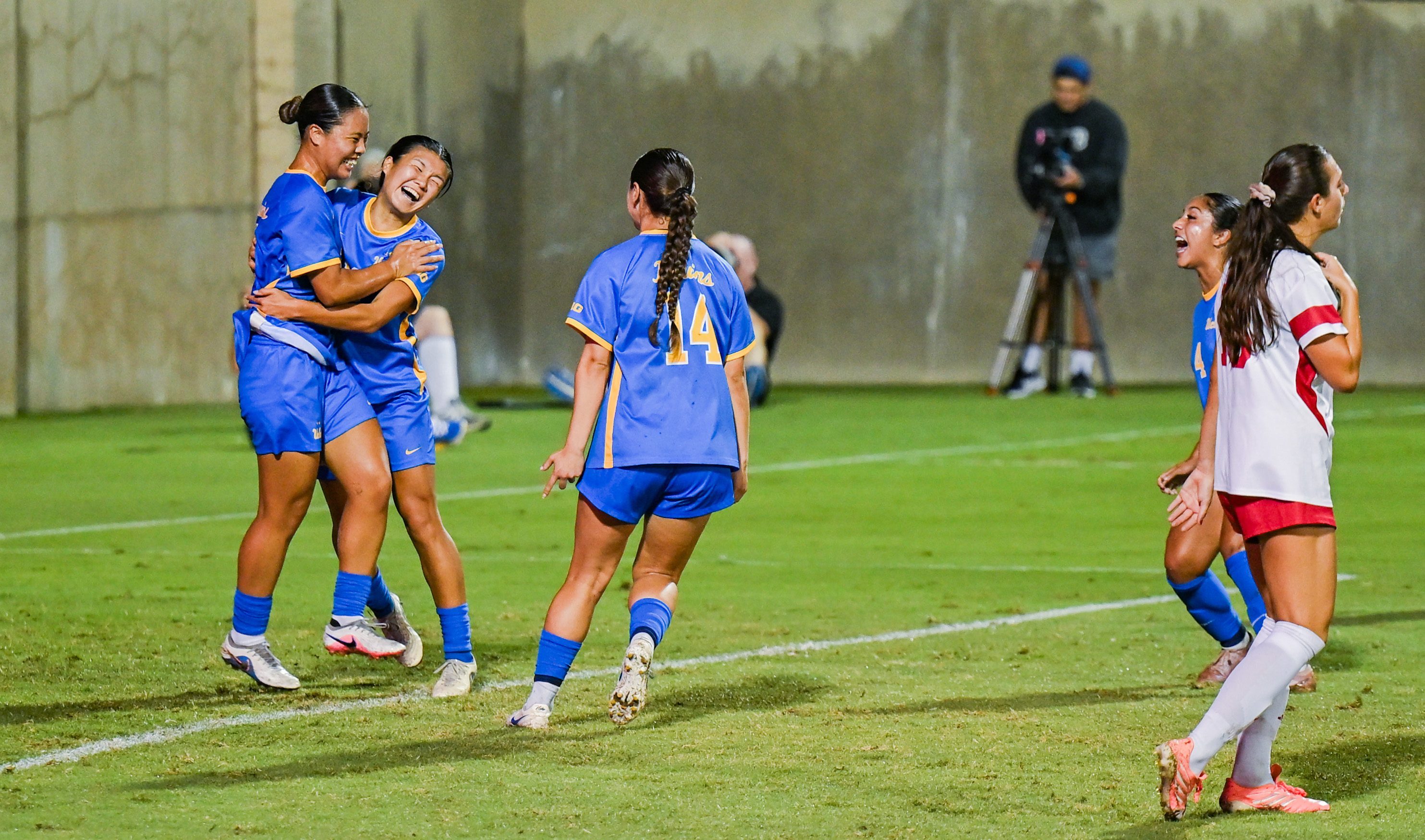 Junior defender Asa Yamazaki (far left) and senior forward Oruha Hayashi (second from left) hug after a goal. (Kai Dizon/Assistant Photo editor)