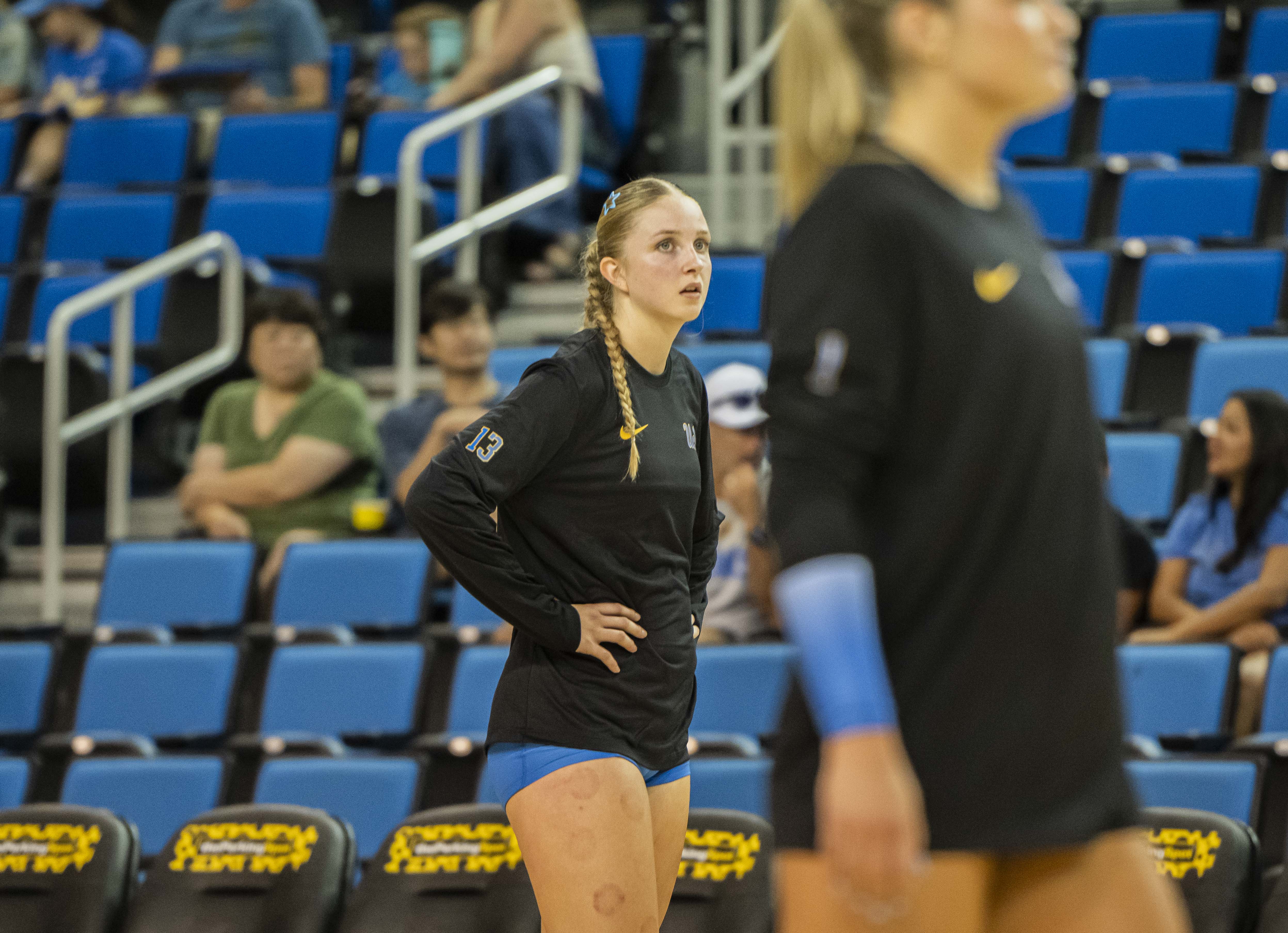 Freshman middle blocker Brooke Harwood stands in line during warmups before a game. The Mesa, Arizona, local has made a splash in her first collegiate career season with 120 kills and 35 blocks thus far. (Amelia Chief/Daily Bruin senior staff)
